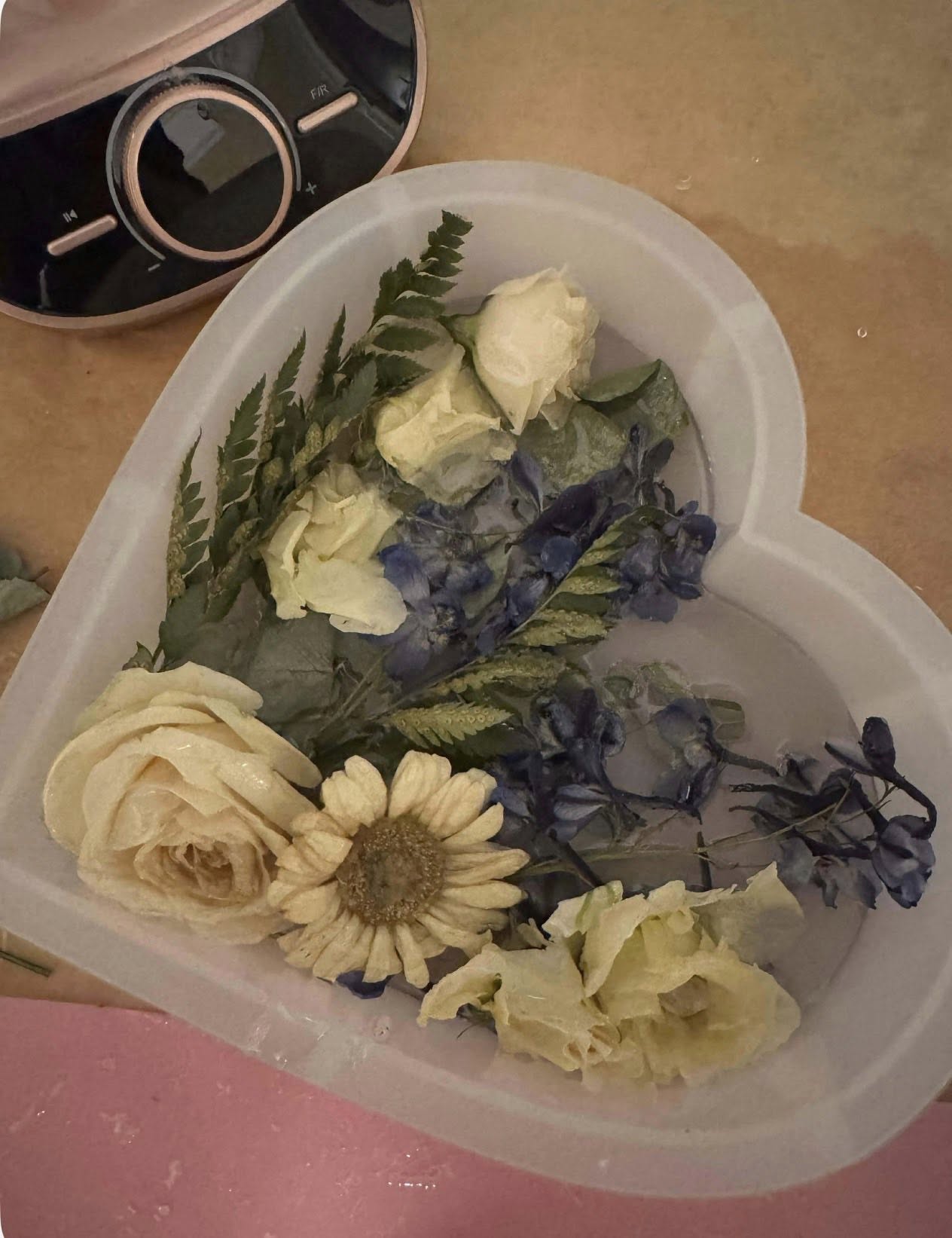 Flowers being preserved in a heart-shaped tray